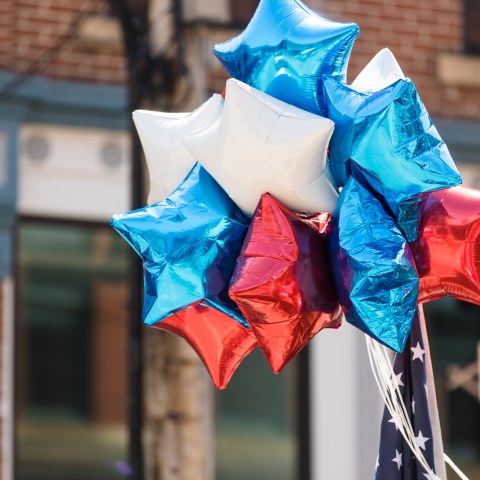 Red white and blue balloons at a parade