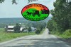 Amish Country Running Festival logo overlayed on photo of a farm along a road with a buggy